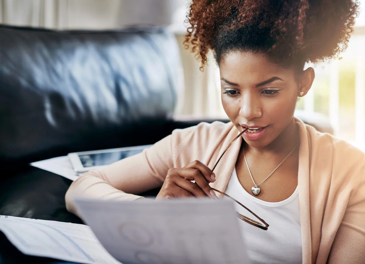 woman looking at papers with glasses