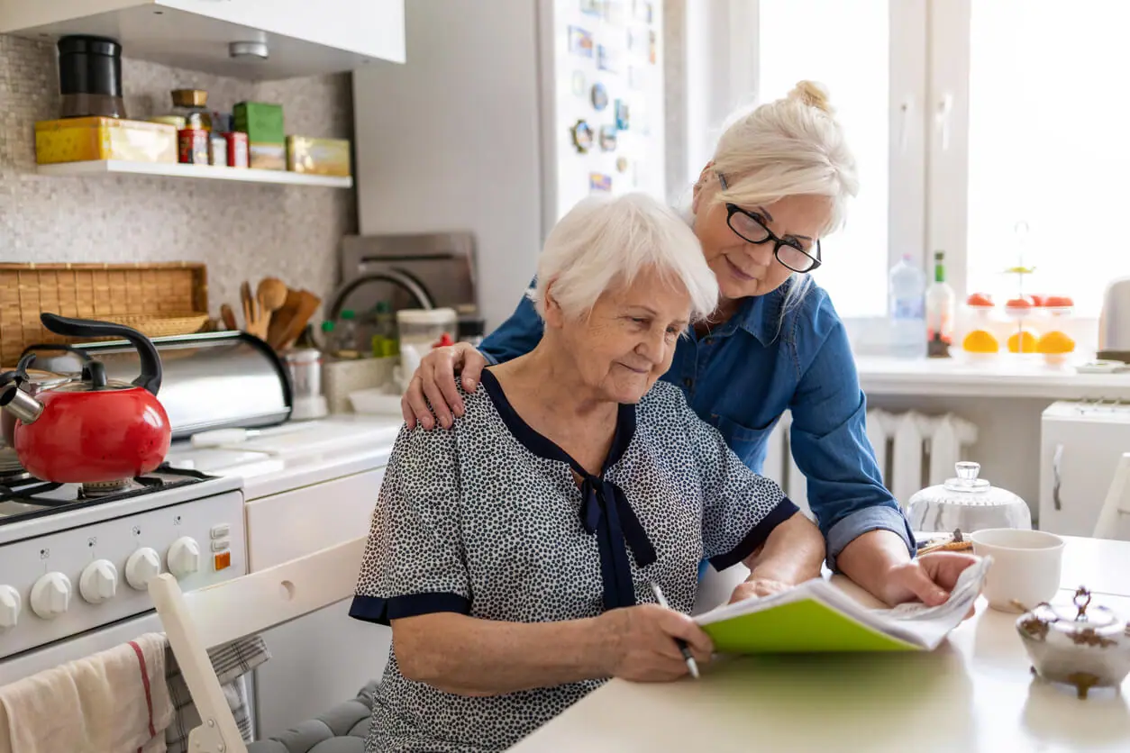 two women looking at paper ss disability access