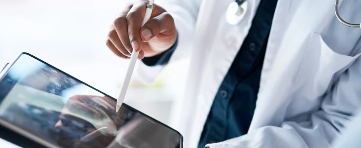 a doctor pointing to a tablet going over results